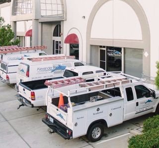 Alexander Pacific Electrical service trucks parked outside the company building
